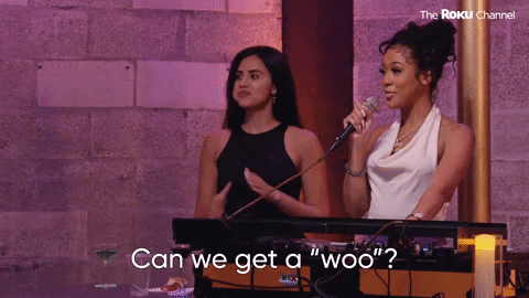 Two ladies raising their glass to give a toast gif