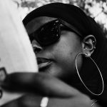 Image of an African feminist reading a book